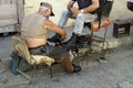 Trinidad, Cuba, circa may 2022: shoeshineboy cleaning shoes in the streets