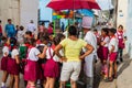 TRINIDAD, CUBA - FEB 8, 2016: Group of Young Pioneer girls and boys at a street food stall in Trinidad, Cub