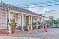 Two girls tourists taking pictures on street near restaurant in colonial old town. Trinidad, Cuba. Royalty Free Stock Photo