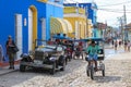 Trinidad,Cuba-November 15,2017.Street urban scene with old car,tricycle,colorful houses.American classic car and lifestyle in Cuba Royalty Free Stock Photo