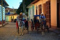Cuba. Two horse-drawn cabs on a shady street in Trinidad