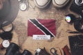 Trinidad and Tobago Flag Between Traveler`s Accessories on Old Vintage Map. Overhead Shot Royalty Free Stock Photo