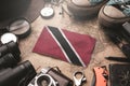 Trinidad and Tobago Flag Between Traveler`s Accessories on Old Vintage Map. Tourist Destination Concept Royalty Free Stock Photo