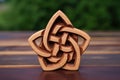 a trinity knot carved on wooden surface