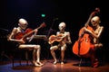 a trio of alien musicians playing their instruments in harmony at a concert hall Royalty Free Stock Photo