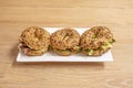 Trio of bagels filled with lettuce and Iberian ham with lots of sesame and poppy seeds Royalty Free Stock Photo