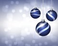 Trio of Blue and Silver Christmas Ornaments on Twinkling Background