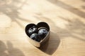 Metallic heart blueberry trio container on wooden board Royalty Free Stock Photo