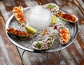 Trio Ceviche, marinated seafood dish, scallop, sea bass, tuna. Haute cuisine. On a wooden background Royalty Free Stock Photo