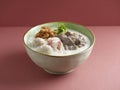 trio Combination Chicken Meatball Congee served in a dish isolated on mat side view on grey background