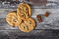 Trio of cooked cookies with chocolate chips seen on a wooden, kitchen preparation surface. Royalty Free Stock Photo