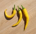 A Trio of Curved Yellow Cayenne Peppers