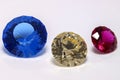 A trio of Detail photos of a self-cut Synthetic Spinel with Zirconiumblue color and Inline Crown cut, quartz with light citrin col