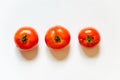 Trio of fresh red tomatos isolated in white background viewed from above
