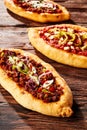 Trio of freshly baked pizza loaves on table Royalty Free Stock Photo