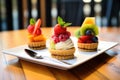 trio of fruit tarts with a scoop of ice cream