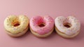 Trio of heart-shaped donuts with colorful icing and sprinkles on pastel background