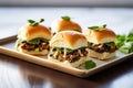 a trio of mini black bean sliders on a sleek metal tray