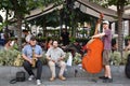 A trio of musicians are playing for people