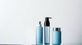 A trio of sleek cosmetic bottles with a minimalist design on a muted backdrop, perfect for branding