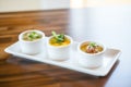 trio of small soup servings, spread for tasting variety