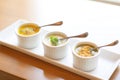 trio of small soup servings, spread for tasting variety