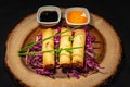 A trio of spring rolls with sauces