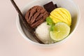 Trio of tasty chocolate vanilla and lime flavored frozen dessert in a white bowl.