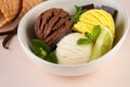 Trio of tasty chocolate vanilla and lime flavored frozen dessert in a white bowl.