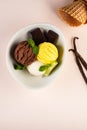 Trio of tasty chocolate vanilla and lime flavored frozen dessert in a white bowl.