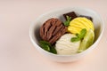 Trio of tasty chocolate vanilla and lime flavored frozen dessert in a white bowl.