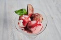 Trio of tasty chocolate vanilla and strawberry flavored frozen dessert in a blue bowl with two wafer straws.