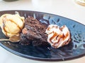 Trio of tasty chocolate vanilla and strawberry flavored frozen dessert in a blue bowl with two wafer straws