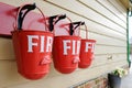 Trio of vintage style Fire Buckets seen at a railway station.