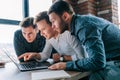 A trio of young professionals in an office, astonished and dumbfounded by the work