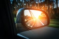 Trip sunset car mirror. Sun, highway car road reflection in mirror. Summer holidays trip concept. Royalty Free Stock Photo