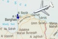 Trip to Benghazi with toy airplane and push pin on map Royalty Free Stock Photo