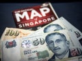Trip to Singapore concept - Singapore dollar and map of Singapore