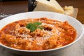 Tripe with tomato sauce called trippa alla romana, a typical dish from Lazio on wooden table