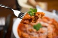 Tripe with tomato sauce called trippa alla romana, a typical dish from Lazio on wooden table