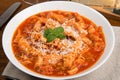 Tripe with tomato sauce called trippa alla romana, a typical dish from Lazio on wooden table