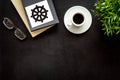 Tripitaka - Buddhist holy book near Wheel of dharma - on black table top view copy space