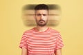 Triple exposure portrait of serious bearded man in red t-shirt looking at camera with angry face.