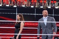 Triple H and Stephanie McMahon smile in the middle of the ring