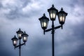 Triple lantern 3 head with transparent glass panels and electric bulb. Royalty Free Stock Photo