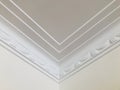 Triple lines and stage opening curtain shaped crown molding in expensive home ceiling at the corner ornamental. Royalty Free Stock Photo
