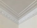 Triple lines and stage opening curtain shaped crown molding in expensive home ceiling at the corner ornamental. Details. Royalty Free Stock Photo