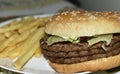 Triple meaty delicious hamburger with nice fries Royalty Free Stock Photo