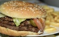 Triple meaty delicious hamburger with nice fries Royalty Free Stock Photo