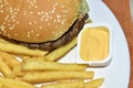 Triple meaty delicious hamburger with nice fries Royalty Free Stock Photo
